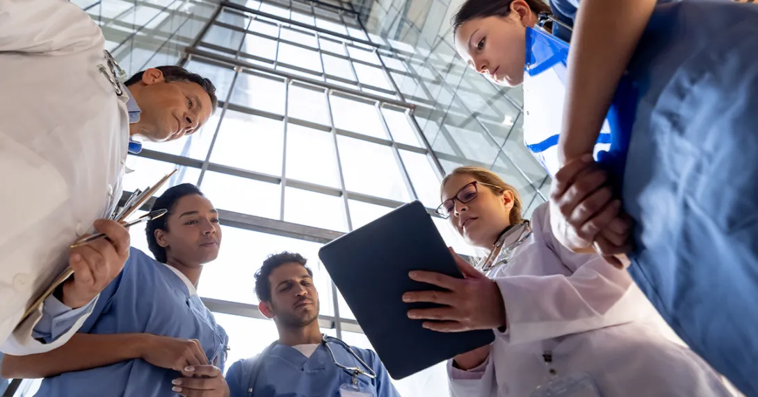 Clinicians reviewing information on a tablet