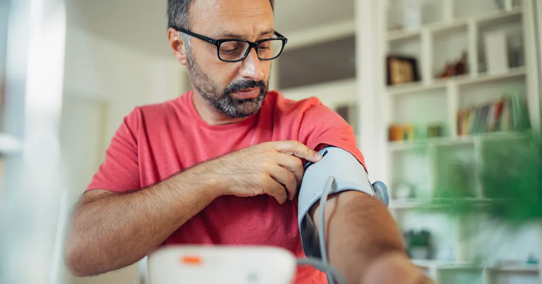 Person using blood pressure cuff