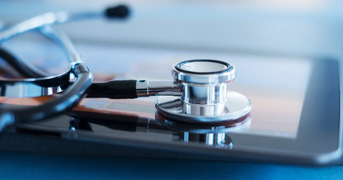 Stethoscope resting on a tablet