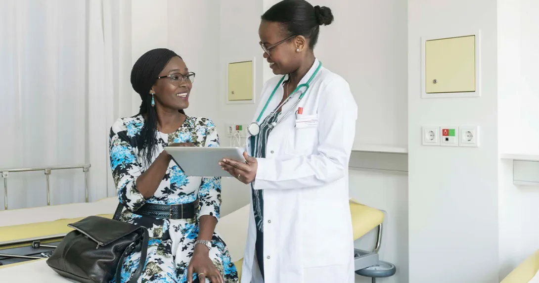 Doctor showing tablet to patient