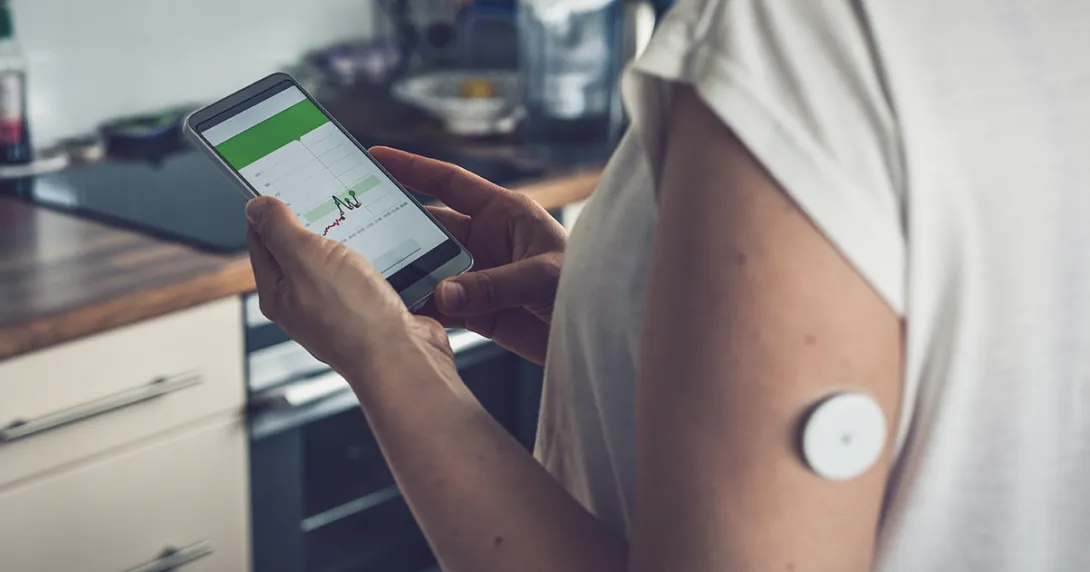 Person wearing monitoring device reviews app results