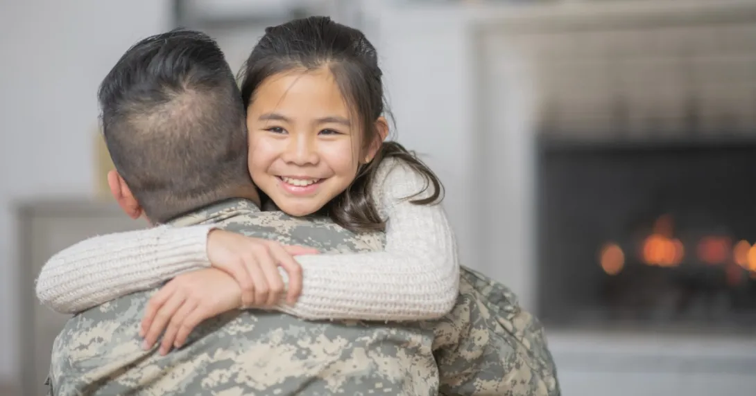 U.S. service member hugs his child