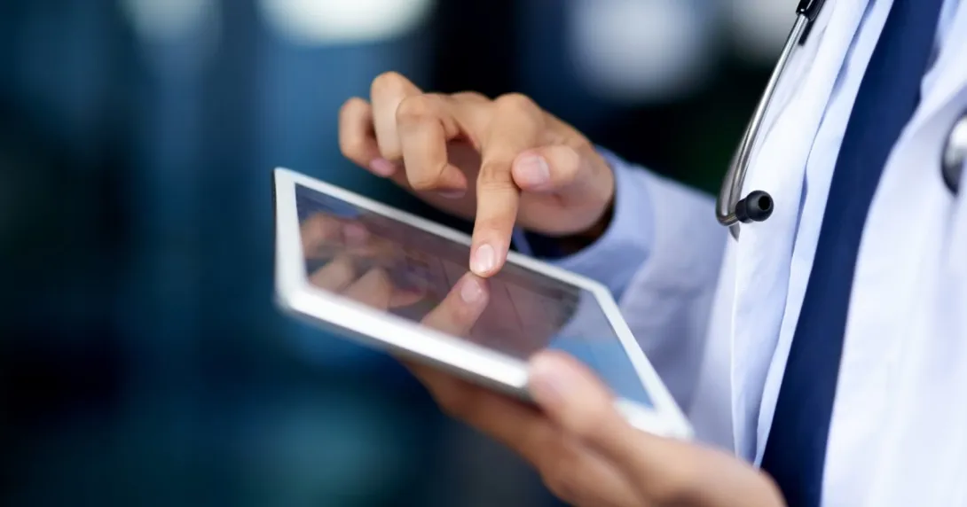 A clinician using an EHR on a tablet