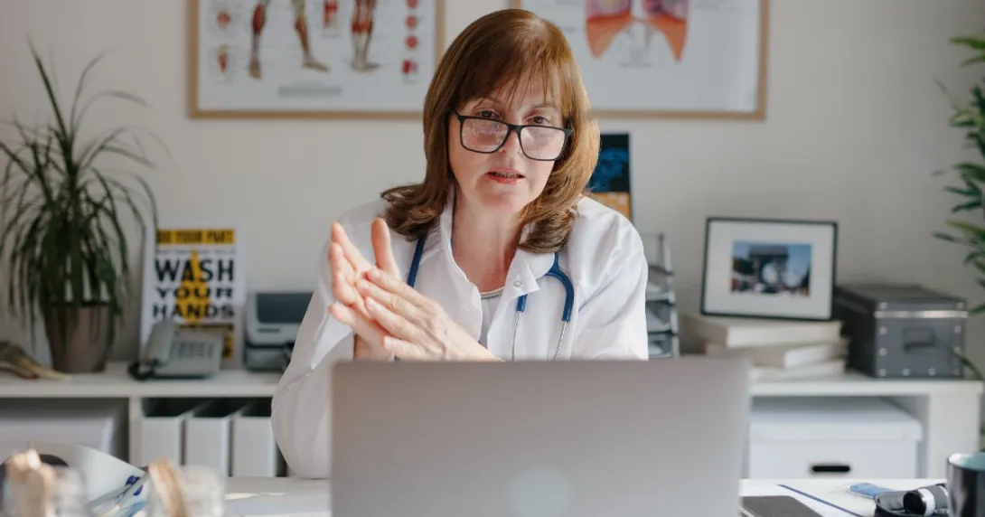 A medical professional on a laptop