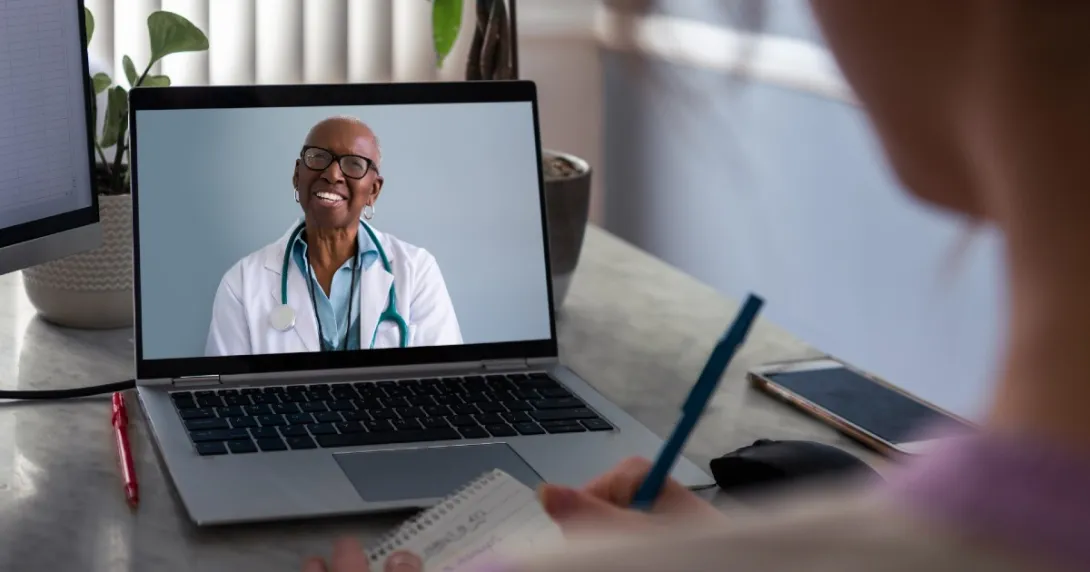 A doctor consults with a patient via video