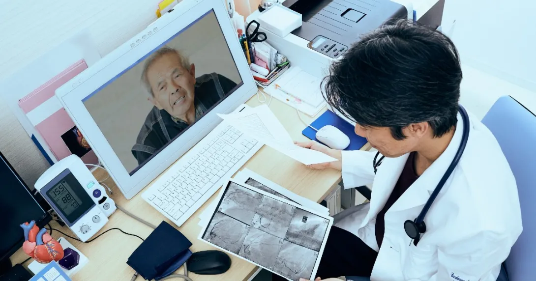 A doctor speaking to a senior on videochat