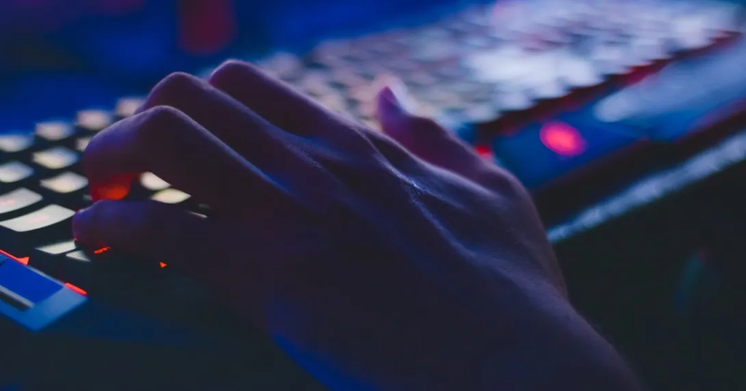 hand on a keyboard in the dark