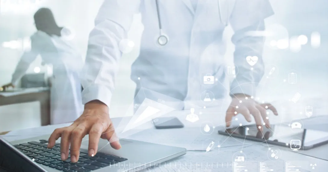 Healthcare professional with tablet and laptop