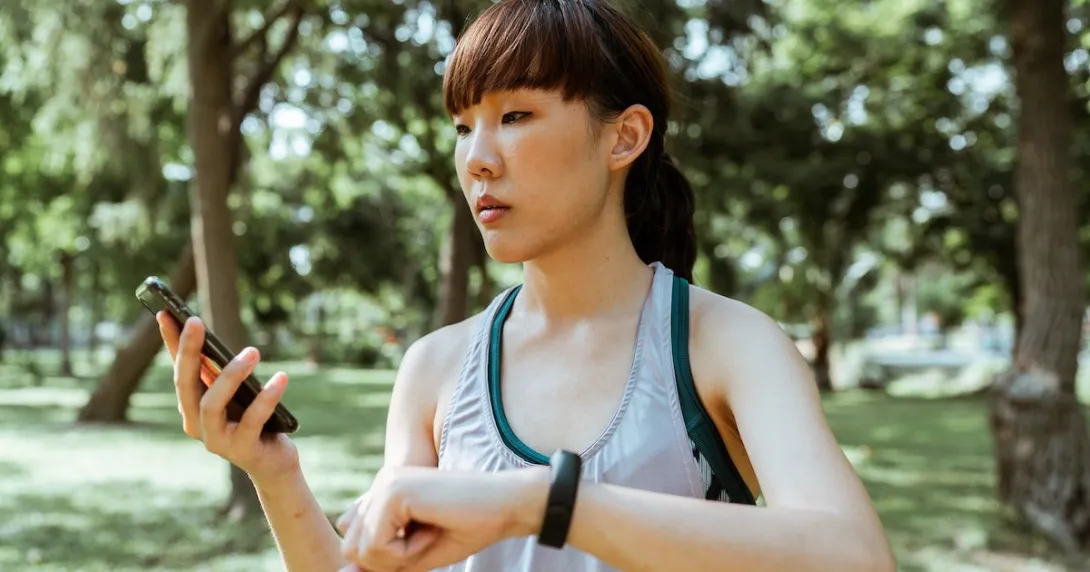 A person checking their vitals on a fitness tracker-paired smartphone