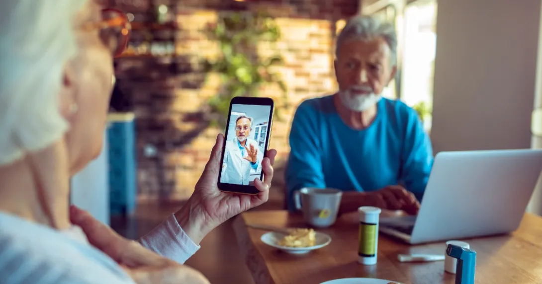 Two people consult with a doctor via telehealth