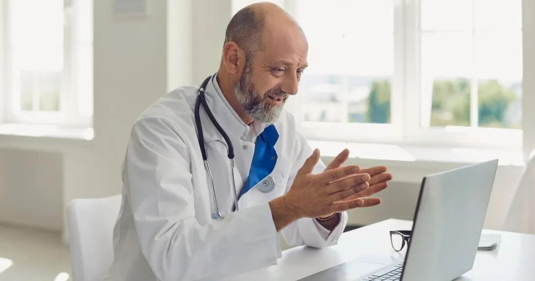 A doctor conducting teleconsultation using a laptop computer