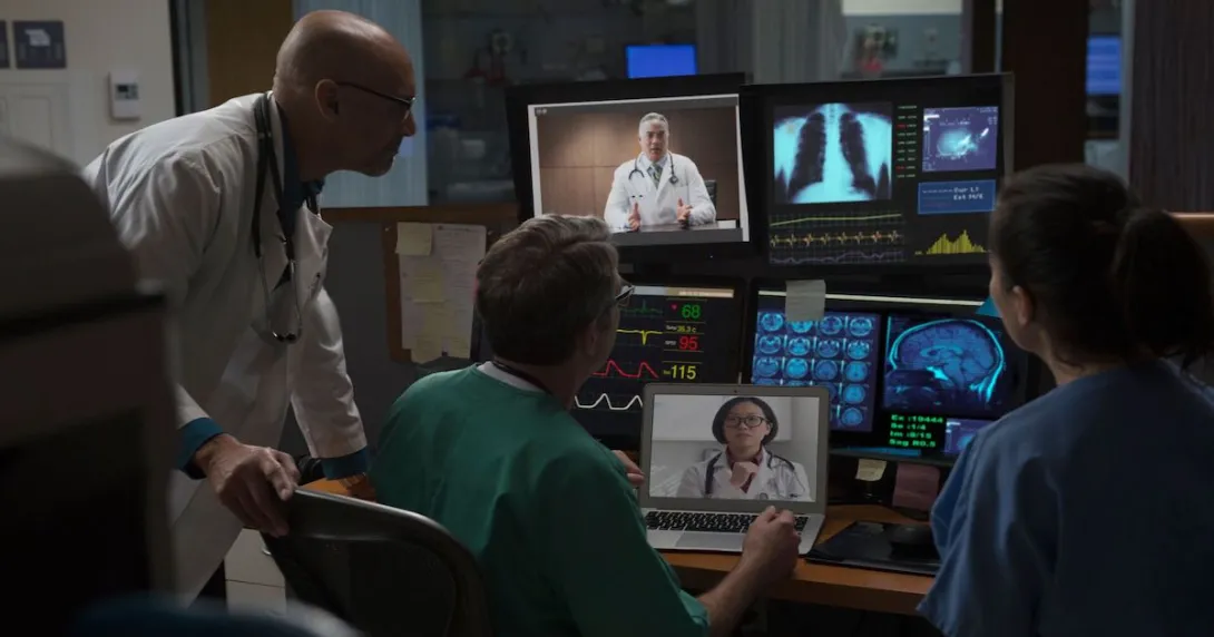 Doctors in a mixed virtual and in-person case conference