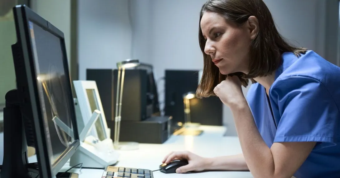A clinical staff looking at a desktop computer