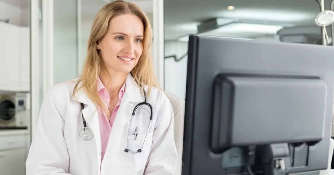 A doctor using a desktop computer