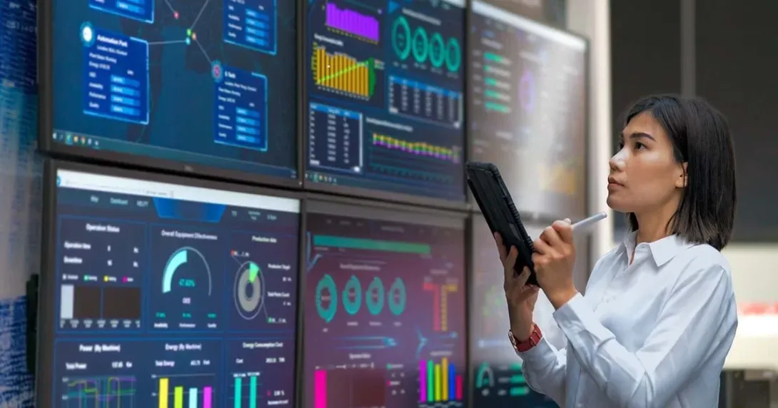 Woman holding a tablet reviews AI data dashboards