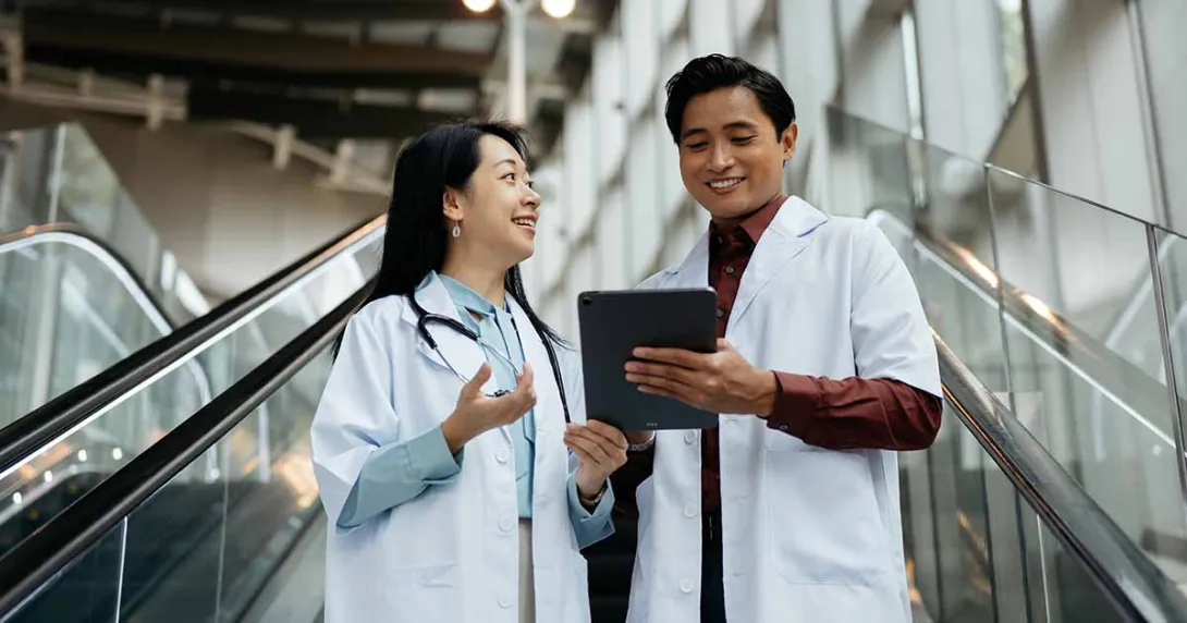 Doctors looking at tablet and talking