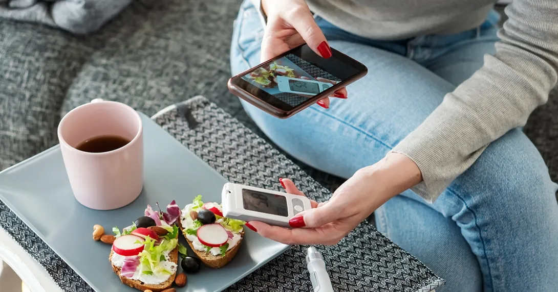 Mid adult diabetic woman having breakfast at home 