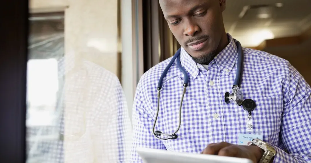 Doctor reviews data on a tablet