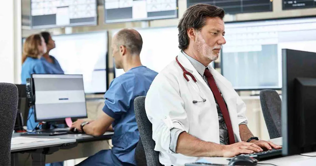 Healthcare workers using computers in an office