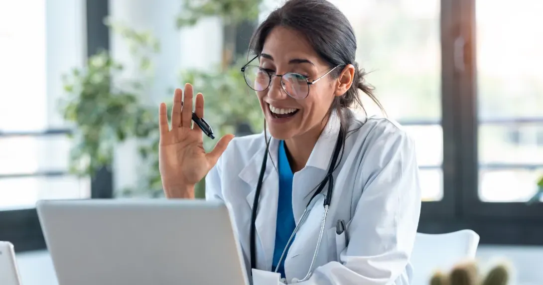 Doctor speaks to a telehealth patient on her laptop 