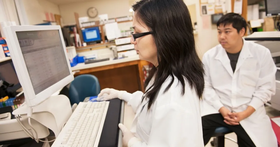 Laboratory researchers reviewing data