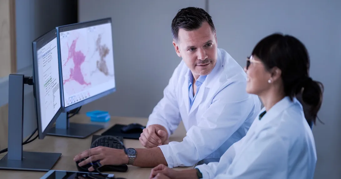 Two pathologists analysing digital slides
