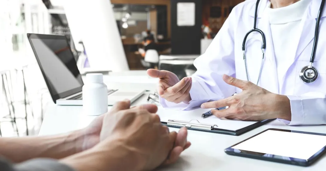 A doctor and patient in a physical clinic consultation