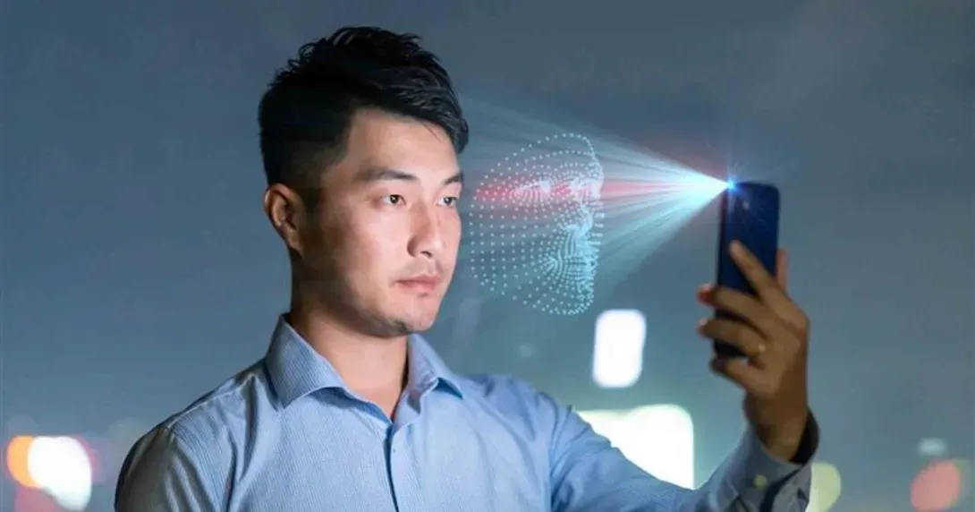 Man holds cell phone up for facial identification