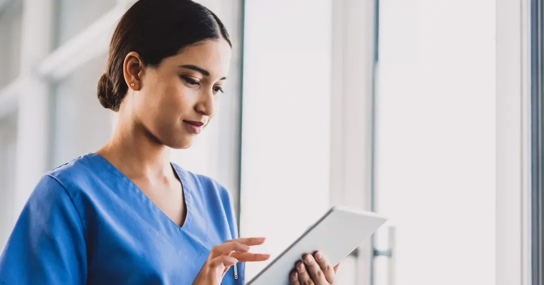 Nurse trains on EHR processes with tablet