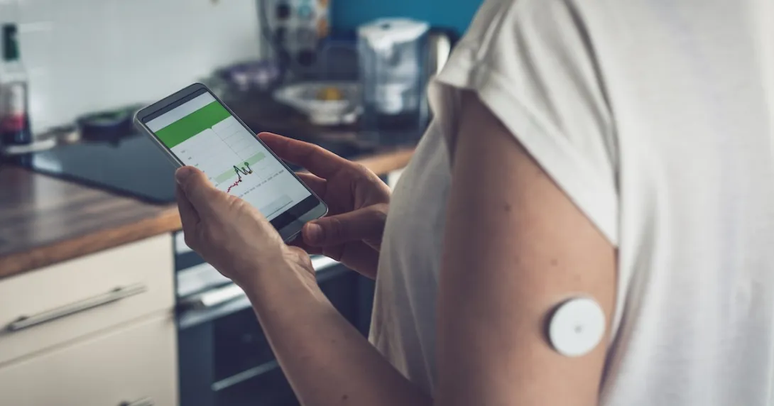 A diabetes patient tracking their blood glucose on a mobile app