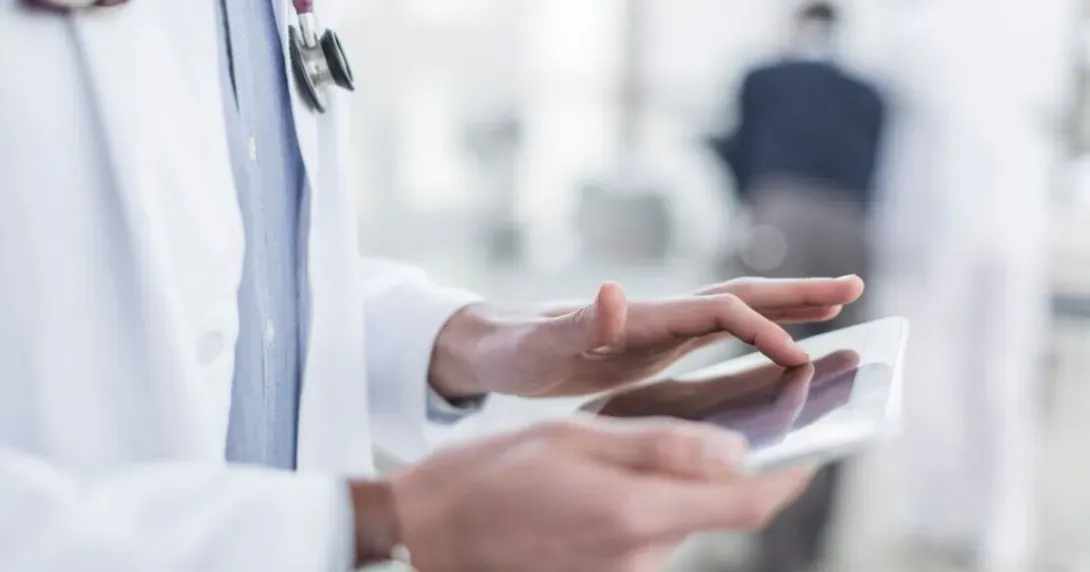 Doctor reviews information on a tablet