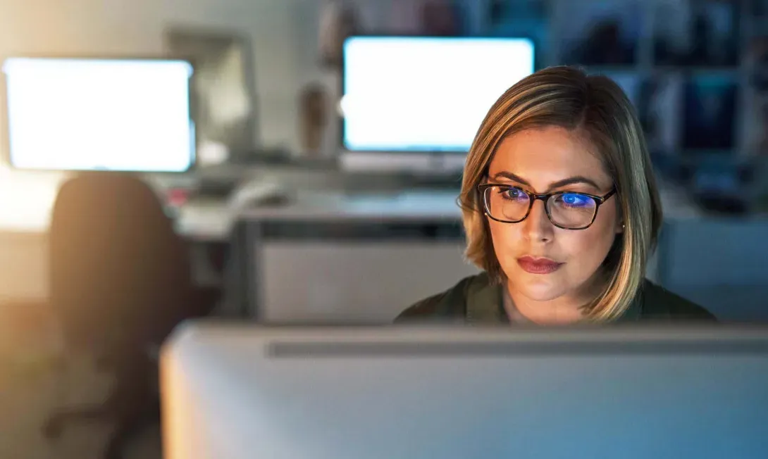 Revenue cycle management employee at a computer terminal  