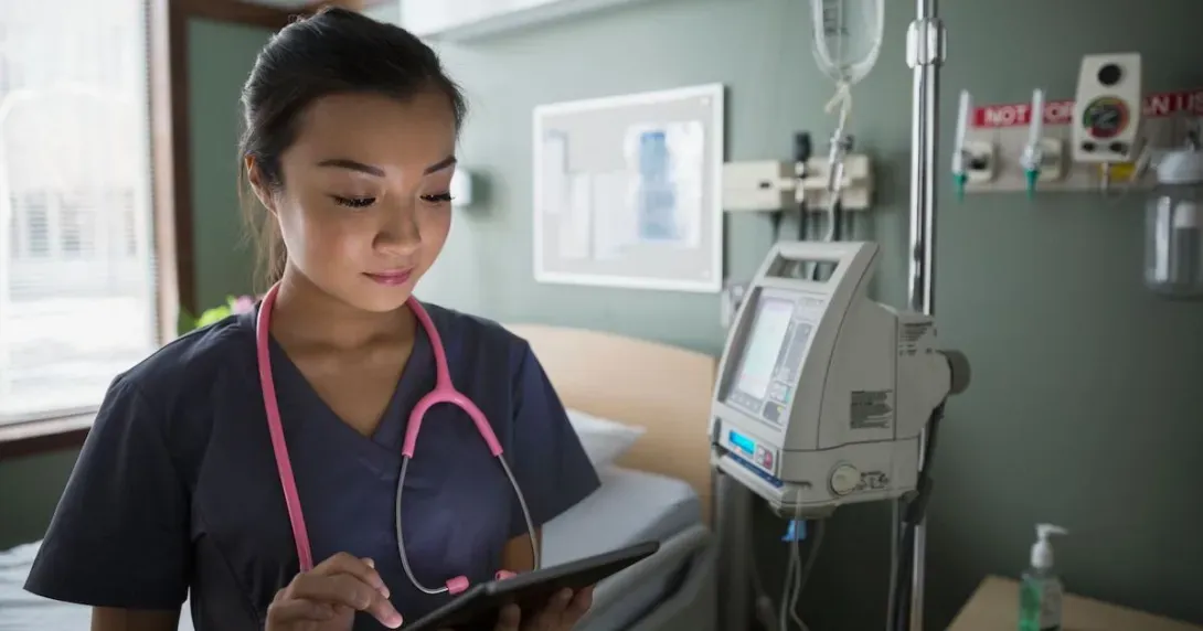 Doctor in a hospital looks up data on a tablet