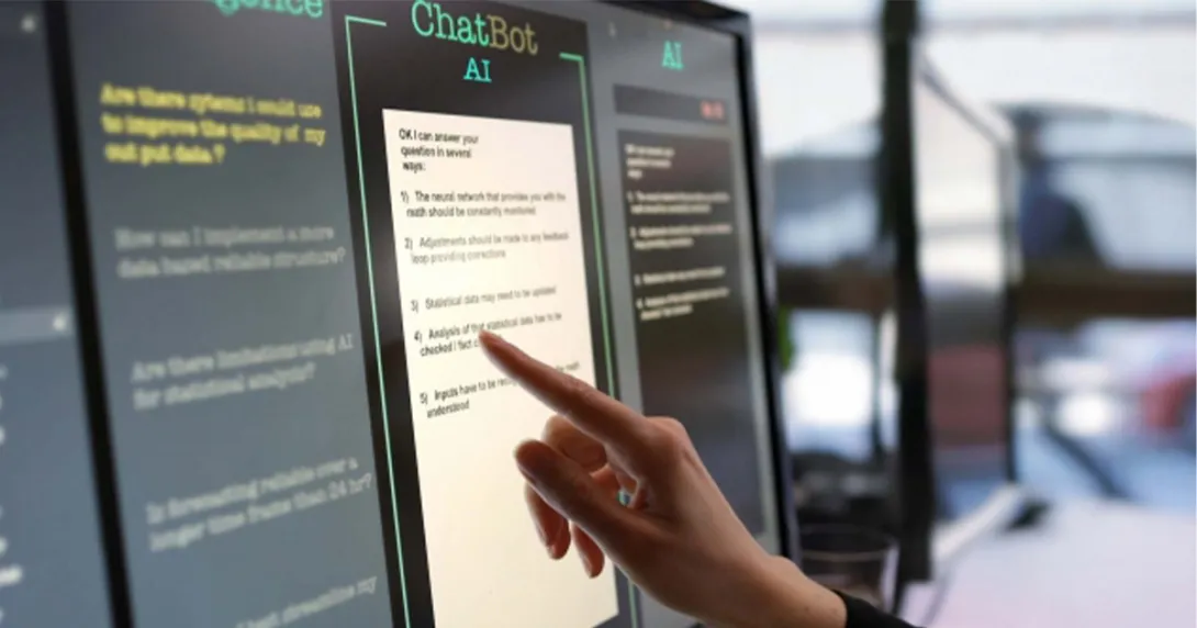 A hand selects text on an AI chatbot touchscreen