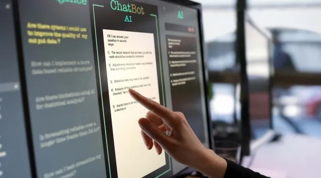 Person touching AI chatbot promot on computer module