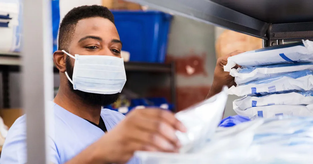 Healthcare worker in mask getting supplies