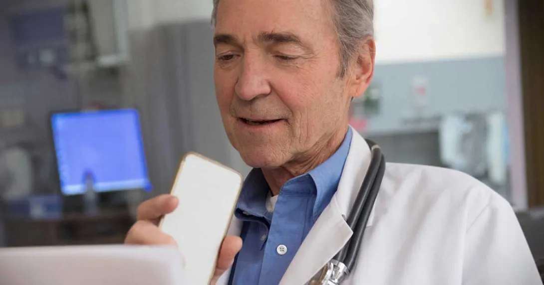 Doctor speaks into a mobile device