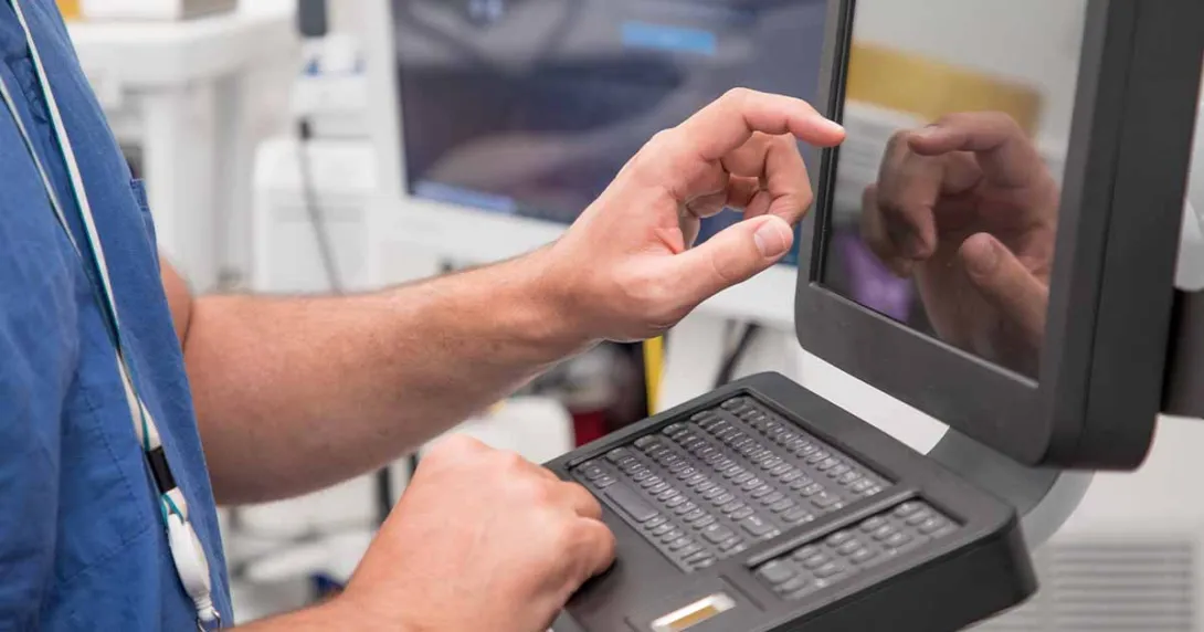 Healthcare worker using touchscreen computer terminal
