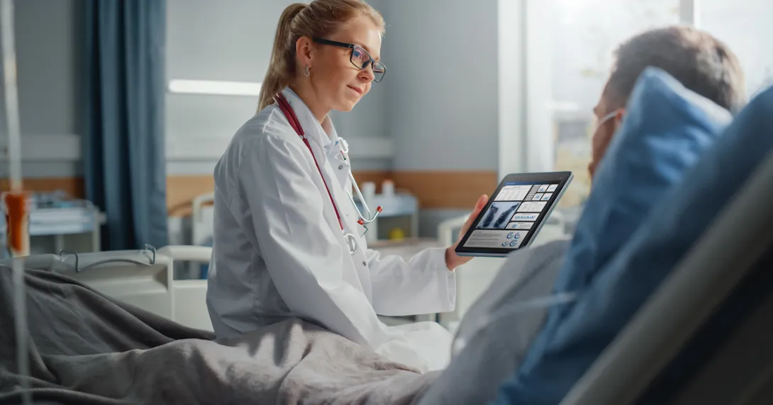 Healthcare worker showing tablet to patient
