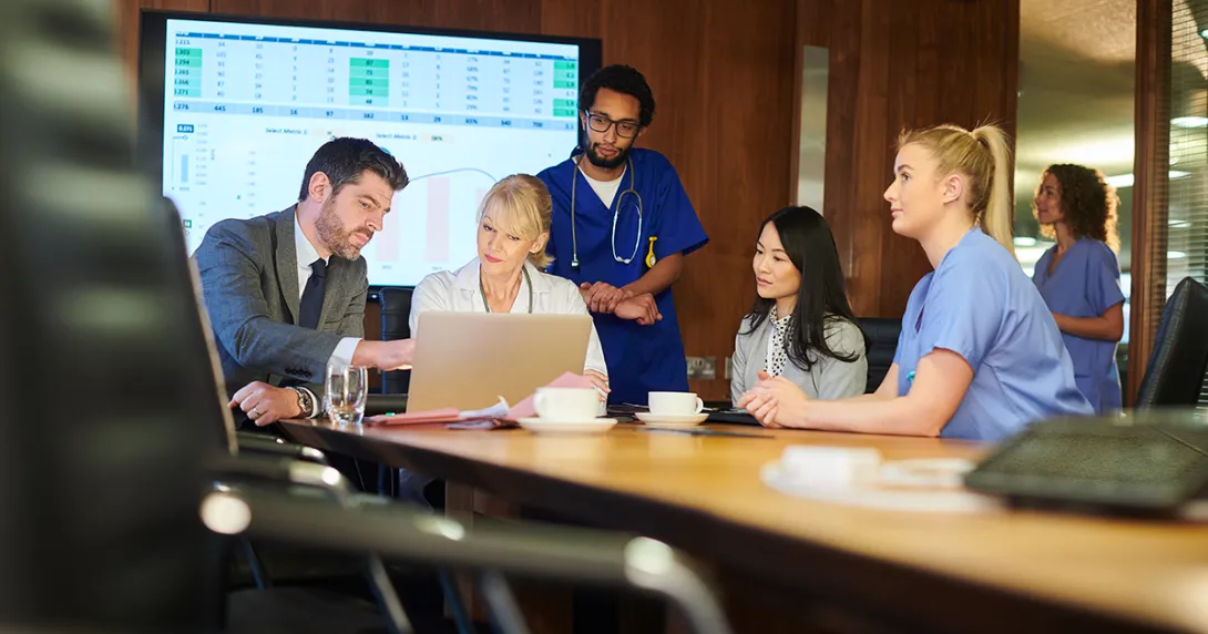 Healthcare workers meeting with business people