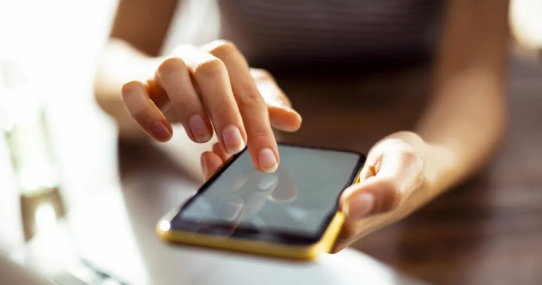 Hands operate a smartphone