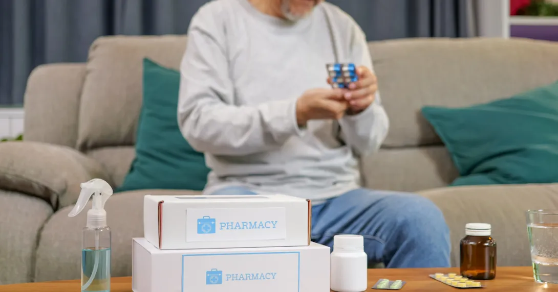 A person reading the label of a medicine packet.