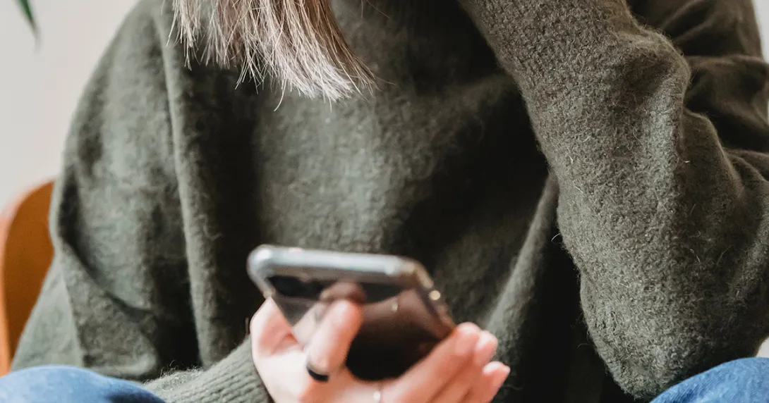 Mobile phone held by person