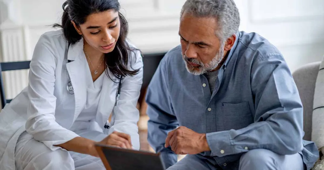 Doctor showing tablet to patient