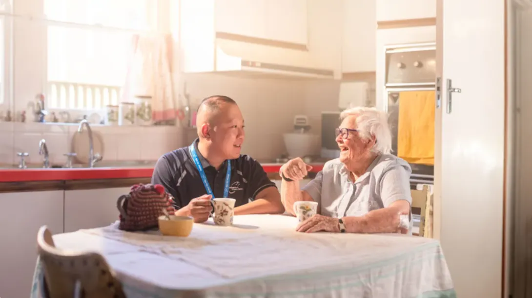 Aged care nurse conversing with a resident