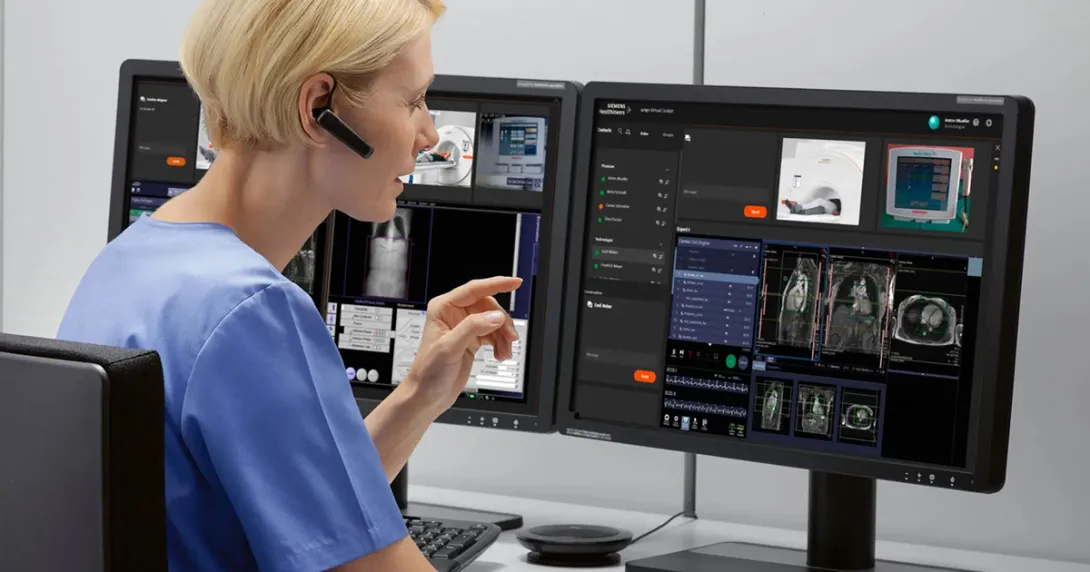 Healthcare worker with eapiece looking at medical images on a computer screen