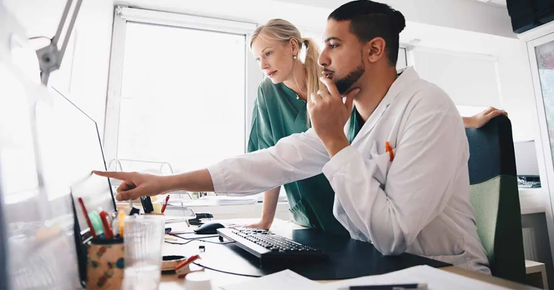 Healthcare worker pointing at a screen