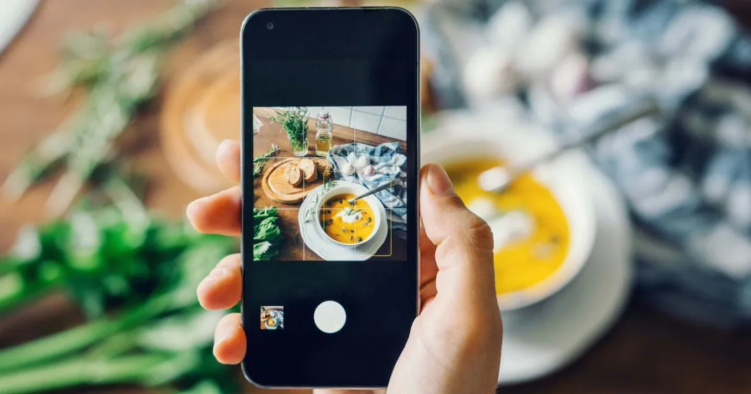 Person taking photo of food with a smartphone