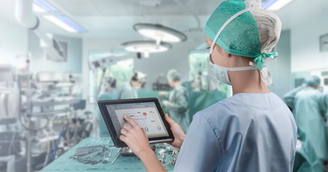 Healthcare worker in surgery room with tablet