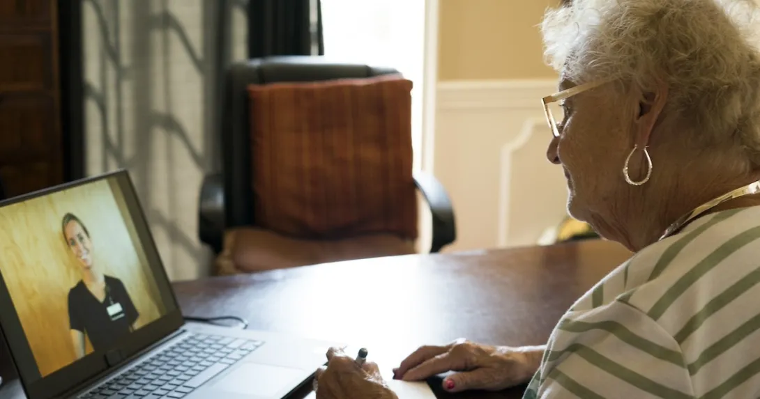 Person speaking to healthcare worker on laptop